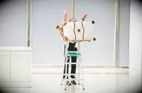 A person pushing the Delsey Paris Chatelet Air 2.0 26 Inch Trunk off of a ladder