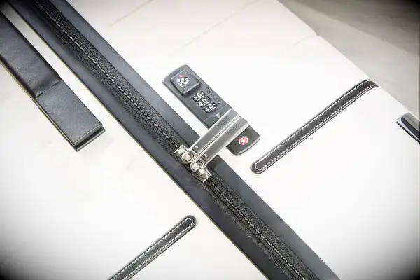 A close-up of the lock on the Travelpro x Travel & Lanetrek Large Check-In Trunk Spinner