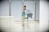 A person pushing the Delsey Paris Cruise 3.0 26 Inch Trunk off of a ladder