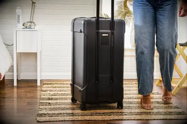 A person next to the Briggs & Riley Extra Large Trunk Spinner