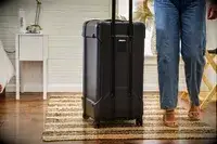 A person next to the Briggs & Riley Extra Large Trunk Spinner