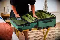 A person opens pockets on the Delsey X Jeep JH002B Large Expandable Spinner Trunk