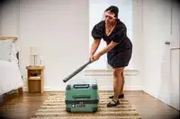 A person hits the Delsey X Jeep JH002B Large Expandable Spinner Trunk with a baseball bat