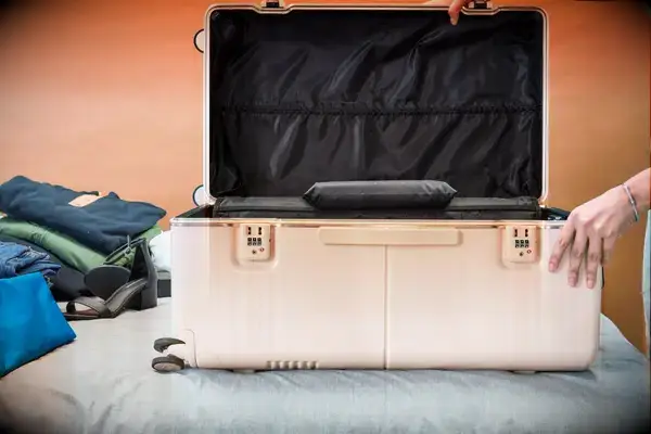 July Checked Trunk open on a bed