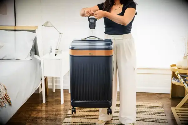 A person weighs the Hartmann Reserve Medium Expandable Trunk