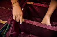 A person opens the pockets on the inside the Hartmann Reserve Medium Expandable Trunk