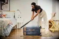A person hits the Hartmann Reserve Medium Expandable Trunk with a baseball bat