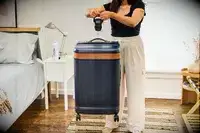 A person weighs the Hartmann Reserve Medium Expandable Trunk