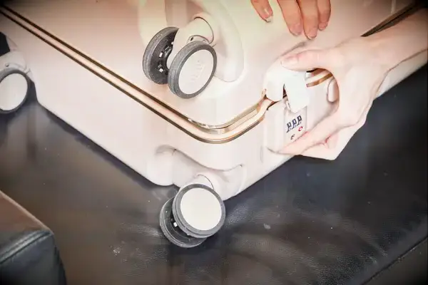 Hand locking the July Carry On Trunk