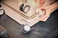 Hand locking the July Carry On Trunk