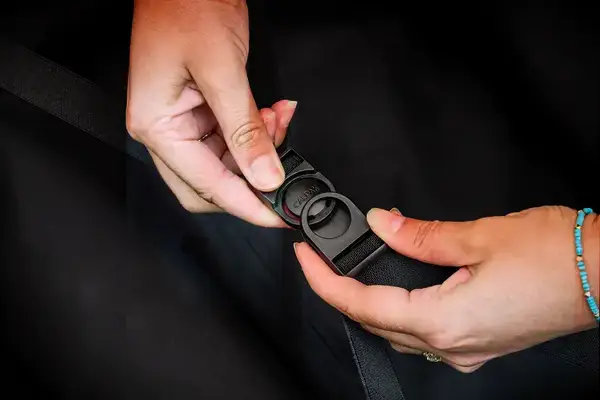 A person snaps the Calpak Hue Trunk Luggage closed