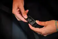 A person snaps the Calpak Hue Trunk Luggage closed