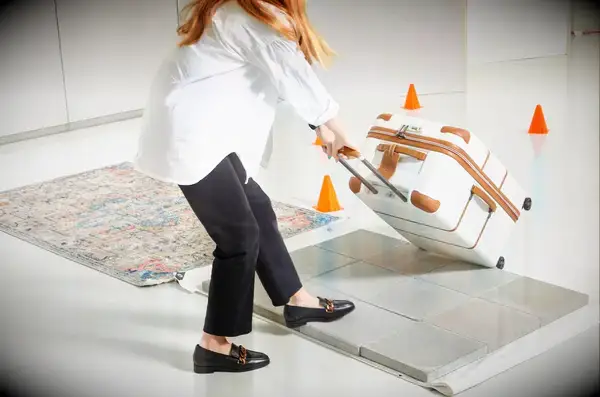 Delsey Paris Chatelet Air 2.0 26 Inch Trunk being rolled onto tile