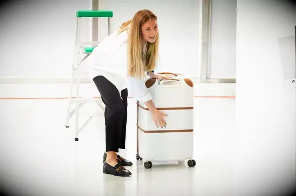 A person holding the Delsey Paris Chatelet Air 2.0 26 Inch Trunk