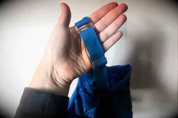 A person holds up the strap on the Sheila Nellie Scoop Bikini Top