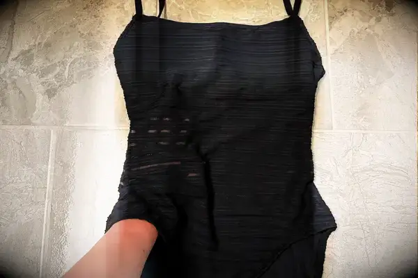 A person with their hand in the La Blanca Island Goddess Lingerie One-Piece Swimsuit