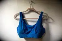 The Sheila Nellie Scoop Bikini Top hangs from a hanger