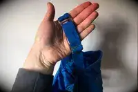 A person holds up the strap on the Sheila Nellie Scoop Bikini Top