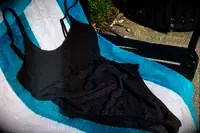 Andie The Amalfi displayed on a striped beach towel