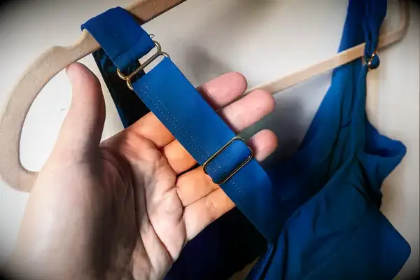 A person touches the adjustable strap on the Sheila Nellie Scoop Bikini Top