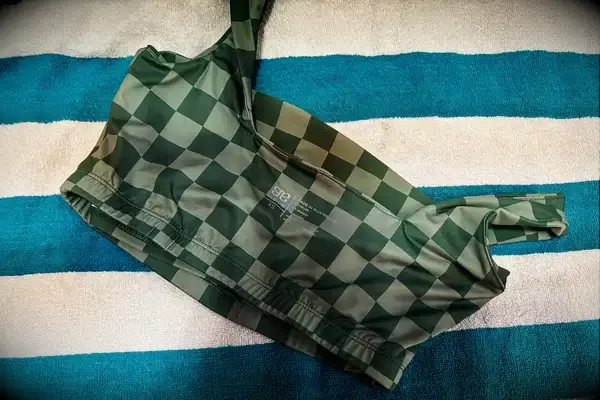 The printed tag on the inside of the Albion Olivia Swim Crop Swimsuit Top