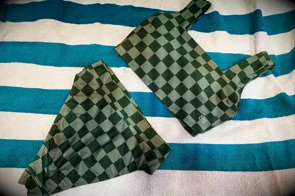 The Albion Olivia Swim Crop Swimsuit Top and Albion Almost Cheeky Swimwear Bottoms on a towel