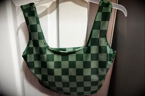 The Albion Olivia Swim Crop Swimsuit Top hangs from a hanger