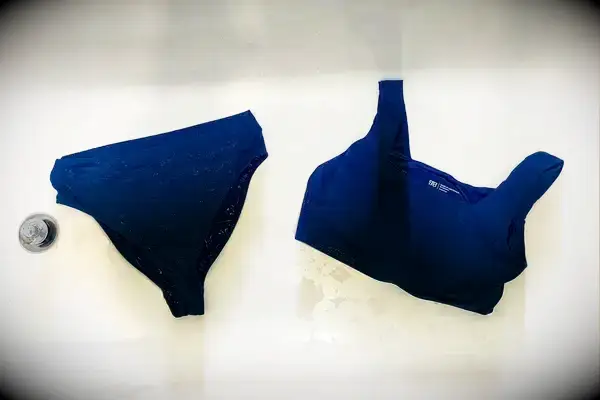 The Albion Olivia Swim Crop Swimsuit Top and Albion Almost Cheeky Swimwear Bottoms in a bathtub