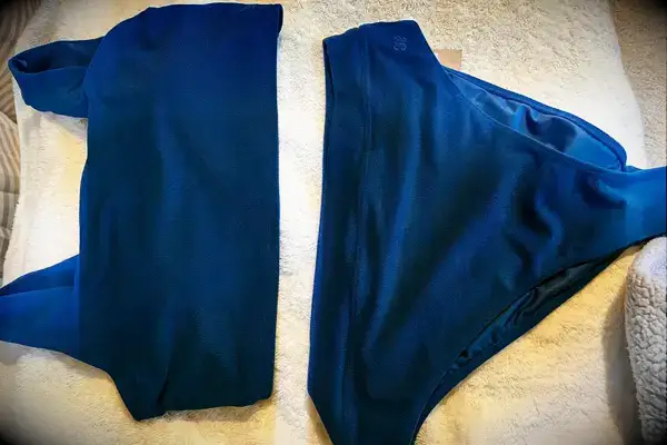 The Albion Olivia Swim Crop Swimsuit Top and Albion Almost Cheeky Swimwear Bottoms on a towel