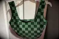 The Albion Olivia Swim Crop Swimsuit Top hangs from a hanger