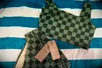 The Albion Olivia Swim Crop Swimsuit Top and Albion Almost Cheeky Bottoms on a towel