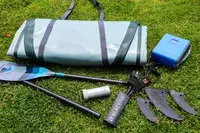 The iRocker BLACKFIN MODEL Inflatable Paddle Board parts on grass