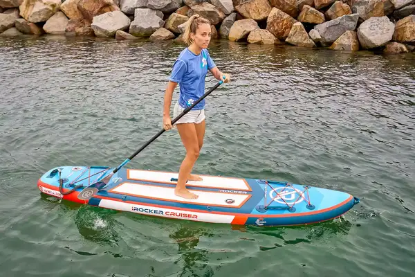 A person paddle boarding on the Bluefin Cruise Carbon