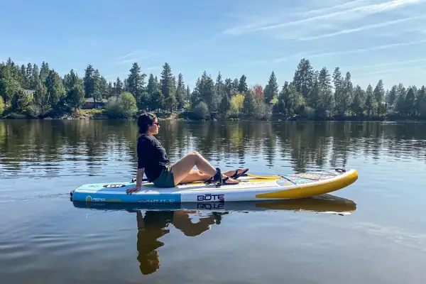 The Isle Pioneer Stand Up Paddle Board deflated on the beach with accessories