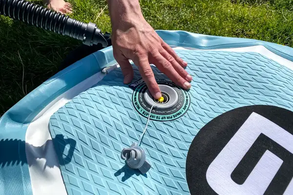 A hand touching the Bōte WULF Aero Inflatable Paddle Board close-up