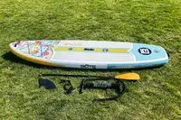 The Bōte WULF Aero Inflatable Paddle Board and its parts on grass
