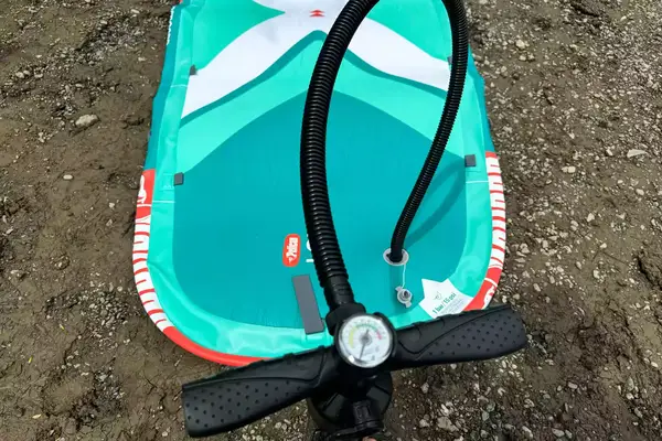 The Pelican Inflatable Loungeboard with Paddle on wet sand