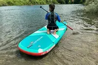 A child on the Pelican Inflatable Loungeboard with Paddle