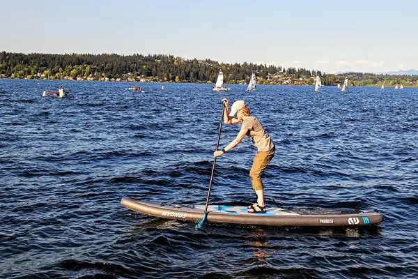A person using the Hydrus Paradise Touring Inflatable Paddle Board in water