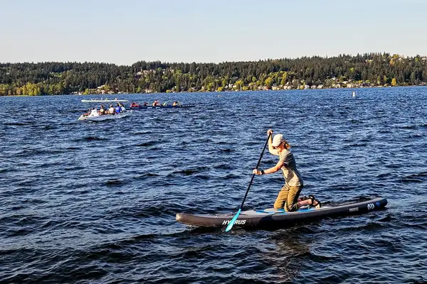 A person using the Hydrus Paradise Touring Inflatable Paddle Board in the water