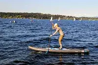 A person using the Hydrus Paradise Touring Inflatable Paddle Board in water