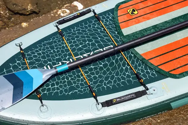 A paddle on top of the iRocker BLACKFIN MODEL Inflatable Paddle Board up close