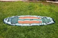 The iRocker BLACKFIN MODEL Inflatable Paddle Board deflated on grass