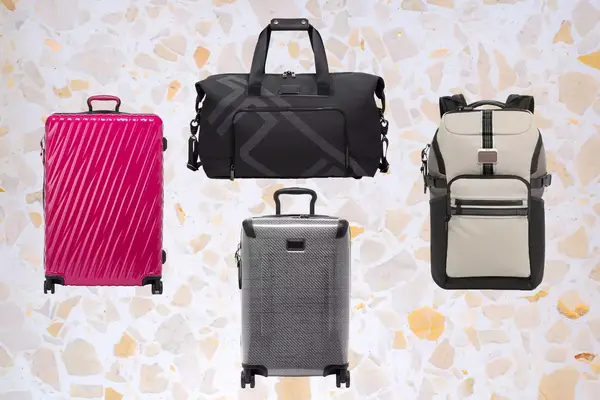 Four different pieces of luggage including rolling suitcases, a duffle bag, and a backpack