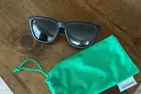 Knockaround Premiums Sport Sunglasses placed on table with green pouch 