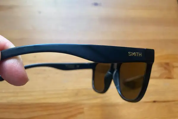 Hand holding Smith Caper Sunglasses with Chromapop