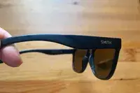 Hand holding Smith Caper Sunglasses with Chromapop