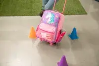 person rolling Stephen Joseph Classic Rolling Luggage