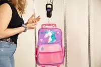 person weighing Stephen Joseph Classic Rolling Luggage