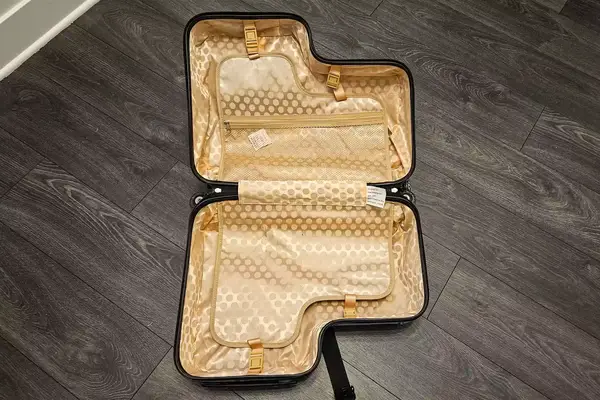 An opened and empty Younglingz Ride On Suitcase on a floor